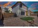 Home's brick-paved backyard with artificial turf, block fencing, and covered patio for outdoor entertaining at 1090 S Bogle Ct, Chandler, AZ 85286