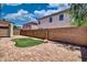 A private brick-paved backyard featuring a small patch of green turf and block wall that adds seclusion at 1090 S Bogle Ct, Chandler, AZ 85286