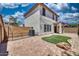 Home's brick-paved backyard with artificial turf, block fencing, and covered patio for outdoor entertaining at 1090 S Bogle Ct, Chandler, AZ 85286