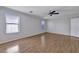 Primary bedroom featuring wood laminate flooring, ceiling fan, and windows at 1090 S Bogle Ct, Chandler, AZ 85286