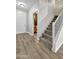 Entryway with wood laminate flooring, staircase, and view of the powder room at 1090 S Bogle Ct, Chandler, AZ 85286