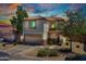 A two-story home with a two car garage and well-maintained desert landscaping in the front yard at 1090 S Bogle Ct, Chandler, AZ 85286