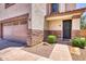 Close up exterior shot shows stone accents and desert landscaping in front of two-car garage at 1090 S Bogle Ct, Chandler, AZ 85286