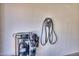 Garage interior featuring a water filtration system and an electric vehicle charger installed on the wall at 1090 S Bogle Ct, Chandler, AZ 85286