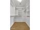Walk-in closet with multiple shelves and hardwood-style flooring at 1090 S Bogle Ct, Chandler, AZ 85286