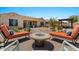 Inviting backyard seating area with a fire pit, lounge chairs, and desert landscaping at 10914 E Tarragon Ave, Mesa, AZ 85212