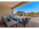 Serene backyard featuring comfortable seating, desert plants, and a covered patio at 10914 E Tarragon Ave, Mesa, AZ 85212
