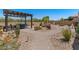 Gorgeous backyard featuring a dining area, desert landscaping, and hardscape pathways at 10914 E Tarragon Ave, Mesa, AZ 85212