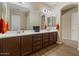 Stylish bathroom with dual sinks, dark wood cabinets, and modern fixtures, offering both style and functionality at 10914 E Tarragon Ave, Mesa, AZ 85212