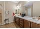 Well-lit bathroom with dual sinks, dark wood cabinets, and modern fixtures, offering both style and functionality at 10914 E Tarragon Ave, Mesa, AZ 85212