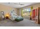 Serene bedroom with natural light, soft bedding, and a soothing color palette, offering a peaceful retreat at 10914 E Tarragon Ave, Mesa, AZ 85212
