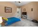 Bedroom with plush carpet, side table, tv, and comfortable twin bed at 10914 E Tarragon Ave, Mesa, AZ 85212