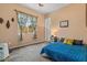 Bedroom with plush carpet, decorated window, and comfortable queen bed at 10914 E Tarragon Ave, Mesa, AZ 85212