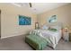 Bright bedroom features two beds, soft lighting, and neutral walls for a welcoming ambiance at 10914 E Tarragon Ave, Mesa, AZ 85212