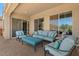 Relaxing covered patio area with cushioned seating and views of the desert landscape at 10914 E Tarragon Ave, Mesa, AZ 85212