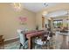 Elegant dining room with stylish lighting and an open view of the living area at 10914 E Tarragon Ave, Mesa, AZ 85212