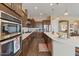Bright kitchen showcases stainless appliances, dual ovens, and a spacious countertop with dark wood cabinets at 10914 E Tarragon Ave, Mesa, AZ 85212