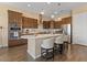 Well appointed kitchen boasts stainless appliances, an island with seating, and attractive cabinetry at 10914 E Tarragon Ave, Mesa, AZ 85212