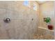 Walk-in shower with decorative tile surround, bench, and shampoo niche at 10914 E Tarragon Ave, Mesa, AZ 85212