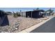 Manufactured home boasts neutral-toned gravel landscaping, enhancing its exterior appeal at 11000 N 91St Ave # 84, Peoria, AZ 85345