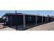 Manufactured home with a long, covered carport provides shade and parking at 11000 N 91St Ave # 84, Peoria, AZ 85345