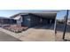 The manufactured home features ample parking under an attached carport at 11000 N 91St Ave # 84, Peoria, AZ 85345