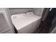 This laundry room features a new Amana washer and dryer at 11000 N 91St Ave # 84, Peoria, AZ 85345
