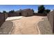 Open backyard featuring a gravel perimeter and a concrete patio at 13004 W Saint Moritz Ln, El Mirage, AZ 85335