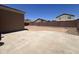 Backyard with concrete patio and gravel landscaping, enclosed by a block wall at 13004 W Saint Moritz Ln, El Mirage, AZ 85335