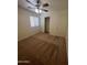 Bedroom featuring carpet flooring, a ceiling fan, a closet, and a window at 13004 W Saint Moritz Ln, El Mirage, AZ 85335
