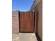 Wood and metal gate providing access to the backyard at 13004 W Saint Moritz Ln, El Mirage, AZ 85335