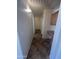 Hallway with tiled floor, white walls, and an access to other rooms at 13004 W Saint Moritz Ln, El Mirage, AZ 85335