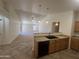 Kitchen with a breakfast bar overlooking the living room, with modern black appliances at 13004 W Saint Moritz Ln, El Mirage, AZ 85335
