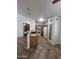 View of the kitchen with tile floors, light wood cabinets, and a decorative glass pantry door at 13004 W Saint Moritz Ln, El Mirage, AZ 85335