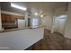 View of kitchen and surrounding areas, with tile floors, glass pantry door, and oak cabinets at 13004 W Saint Moritz Ln, El Mirage, AZ 85335