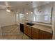 Kitchen breakfast bar area, looking out to the living room with ceiling fans, tile floors at 13004 W Saint Moritz Ln, El Mirage, AZ 85335