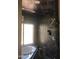Bathroom highlighting a walk-in shower, soaking tub, and dark tiling for a contemporary and relaxing feel at 1502 E Estrid Ave, Phoenix, AZ 85022