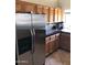 Traditional kitchen featuring stainless steel refrigerator, granite countertops, and warm wood cabinetry at 1502 E Estrid Ave, Phoenix, AZ 85022