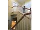 A well-lit staircase with wooden railings leading to the upper level of the home at 1502 E Estrid Ave, Phoenix, AZ 85022