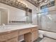 Traditional bathroom boasting a dual sink vanity, shower-tub combo, and patterned flooring at 15377 W Catalina Ct, Goodyear, AZ 85395