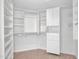 Organized walk-in closet featuring built-in shelving, drawers, and hanging rods for ample storage at 15377 W Catalina Ct, Goodyear, AZ 85395