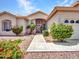 Inviting front entrance with a tiled walkway, lush landscaping, and a covered entryway at 15377 W Catalina Ct, Goodyear, AZ 85395