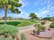 Expansive golf course view with walking path, mature trees, and beautifully landscaped areas at 15377 W Catalina Ct, Goodyear, AZ 85395