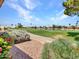 Scenic golf course view with lush green fairways, a water hazard, and clear blue skies at 15377 W Catalina Ct, Goodyear, AZ 85395