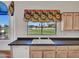 Cozy kitchen featuring bright floral window coverings and golf course views from the window at 15377 W Catalina Ct, Goodyear, AZ 85395