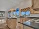 Bright kitchen with views, island, tile countertops, wooden cabinets, and modern appliances at 15377 W Catalina Ct, Goodyear, AZ 85395