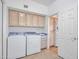 Functional laundry room with washer, dryer, and plenty of cabinet space for storage and organization at 15377 W Catalina Ct, Goodyear, AZ 85395