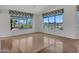 Bright living room featuring hardwood floors and large windows with picturesque views of the golf course at 15377 W Catalina Ct, Goodyear, AZ 85395
