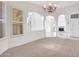 Open living space with large windows, carpeted flooring, and elegant architectural arches at 15377 W Catalina Ct, Goodyear, AZ 85395