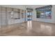 Spacious living room showcasing a large built-in entertainment center and wood flooring throughout at 15377 W Catalina Ct, Goodyear, AZ 85395